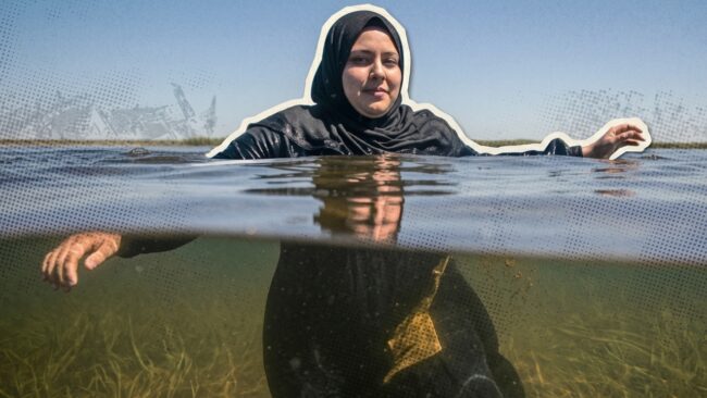 A Muslim woman wades through deep water