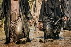 Digital artwork showing a group of Muslim women wading through muddy water on a fundraising challenge