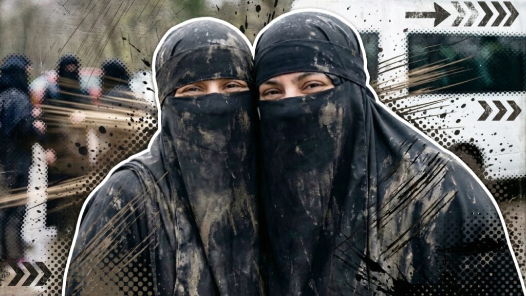Two muddy Muslim women pose for the camera at the end of their challenge