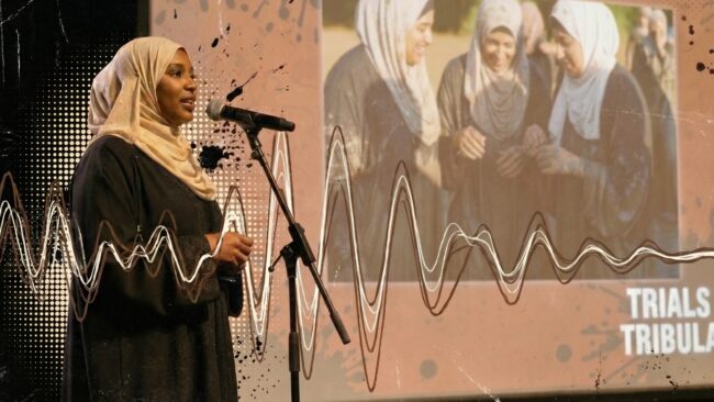 A Muslim woman speaks to an audience about Trials & Tribulations